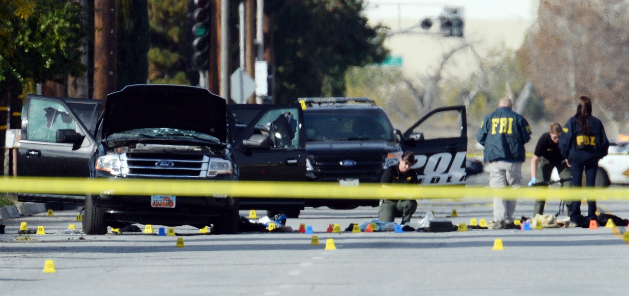 14 people were killed and 21 injured after a man and woman opened fire at the Inland Regional Center in San Bernardino. Police and FBI agents investigate an SUV used by the suspects after a shootout.